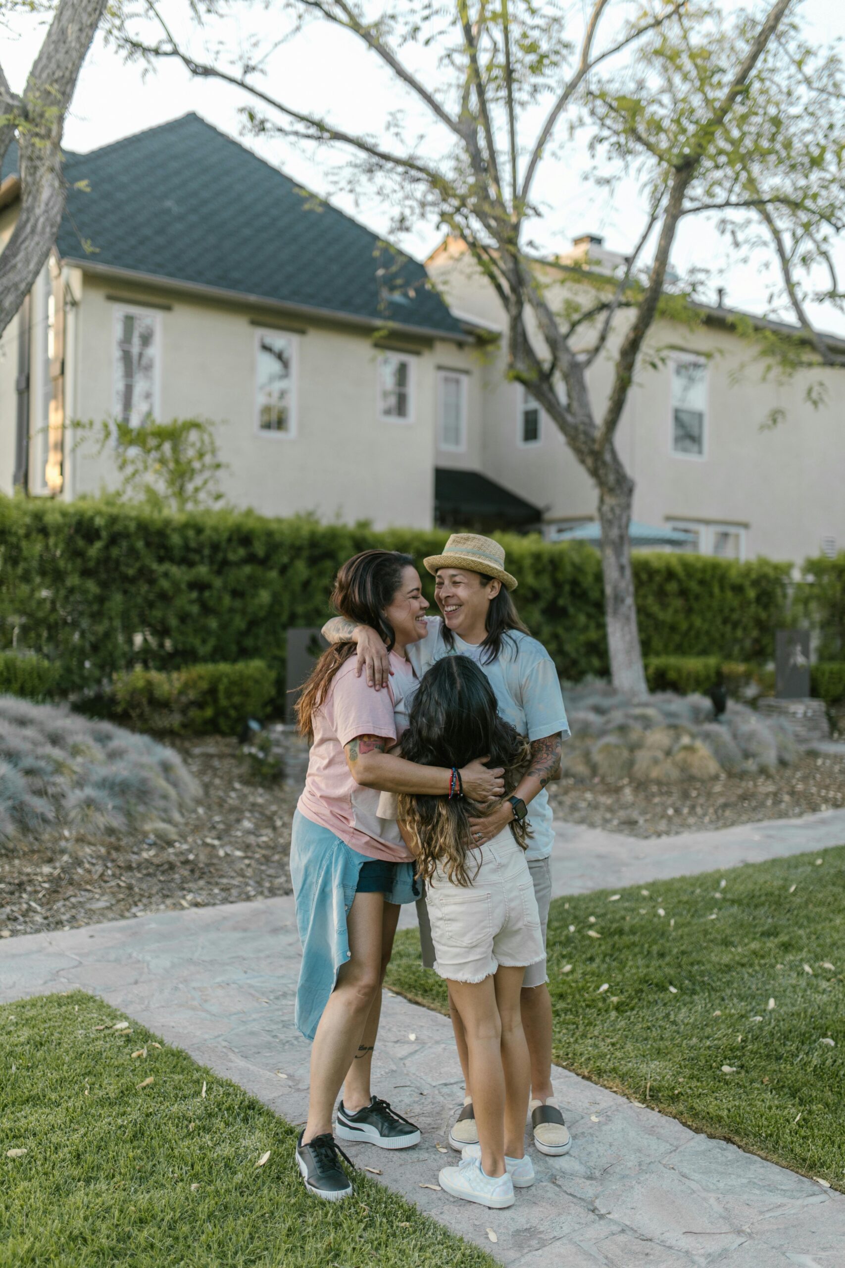 Happy family embraces in a suburban park, enjoying quality time together outdoors.